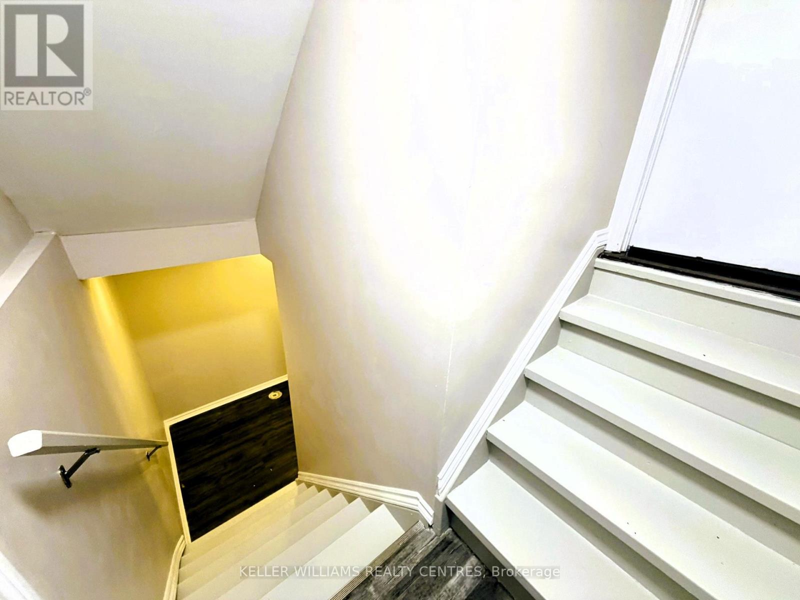 A staircase with a yellow wall on the side.