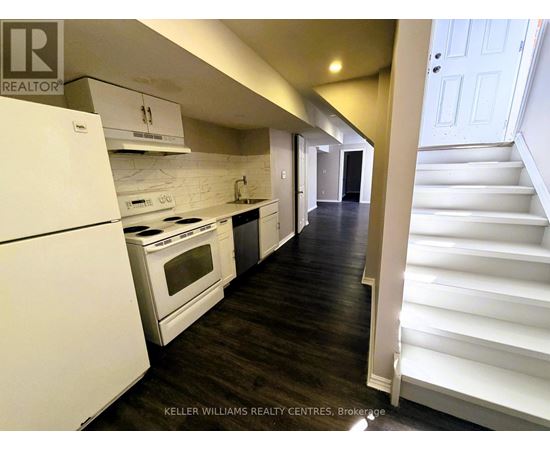 A white kitchen with a white fridge and stove.