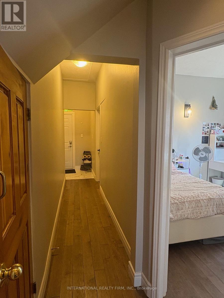 A hallway with a bedroom at the end.