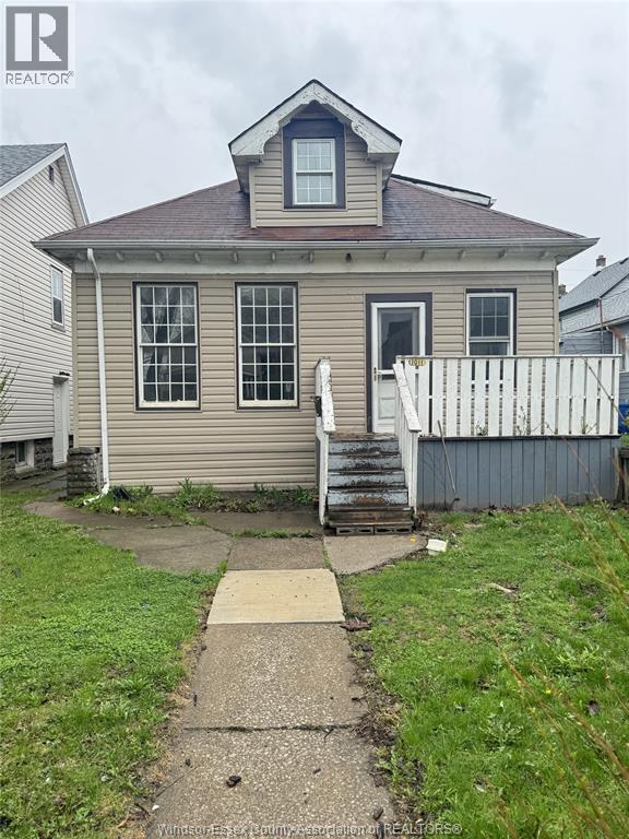 A house with a brown roof and a white fence.