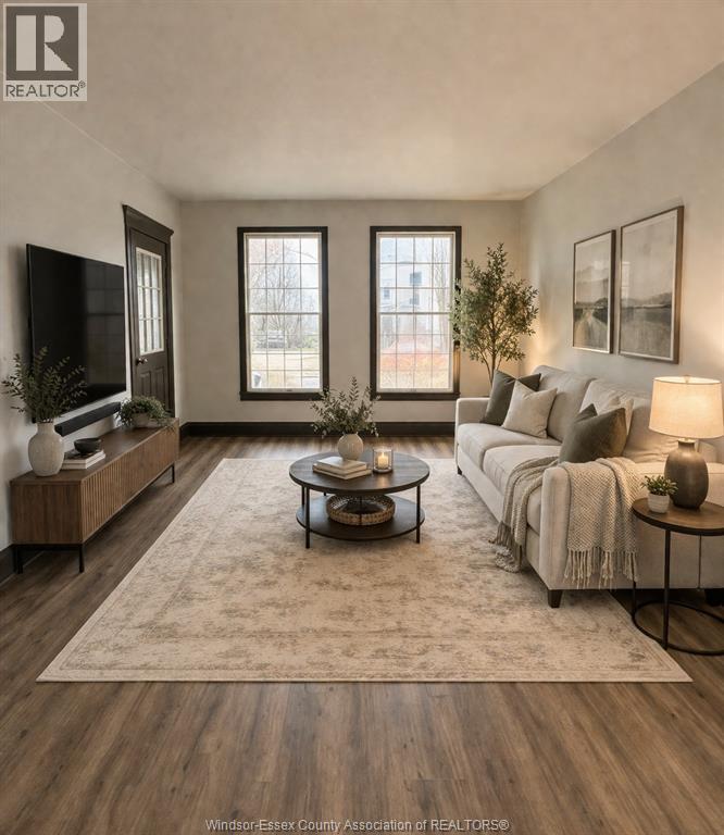 A well-lit living room with a sofa, coffee table, and a television.