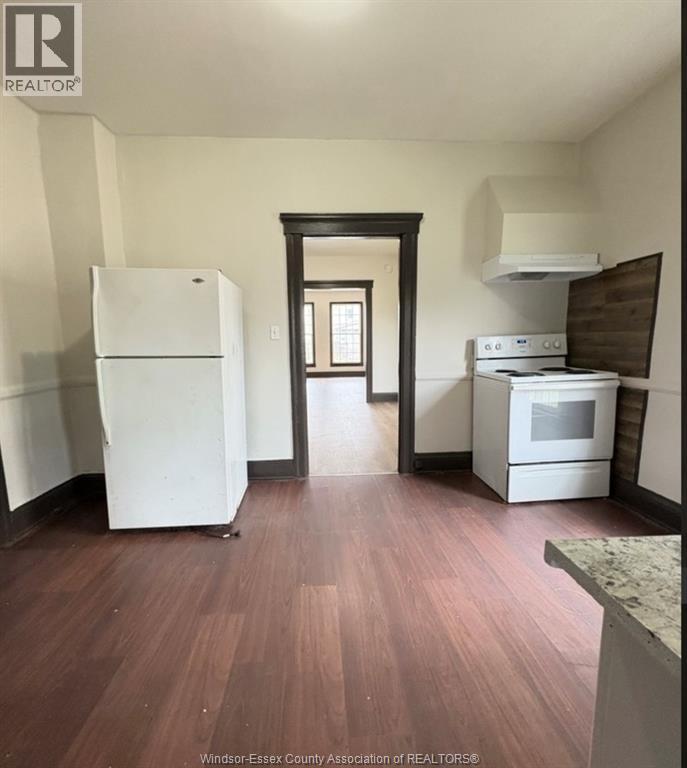 A kitchen with a white fridge and stove.
