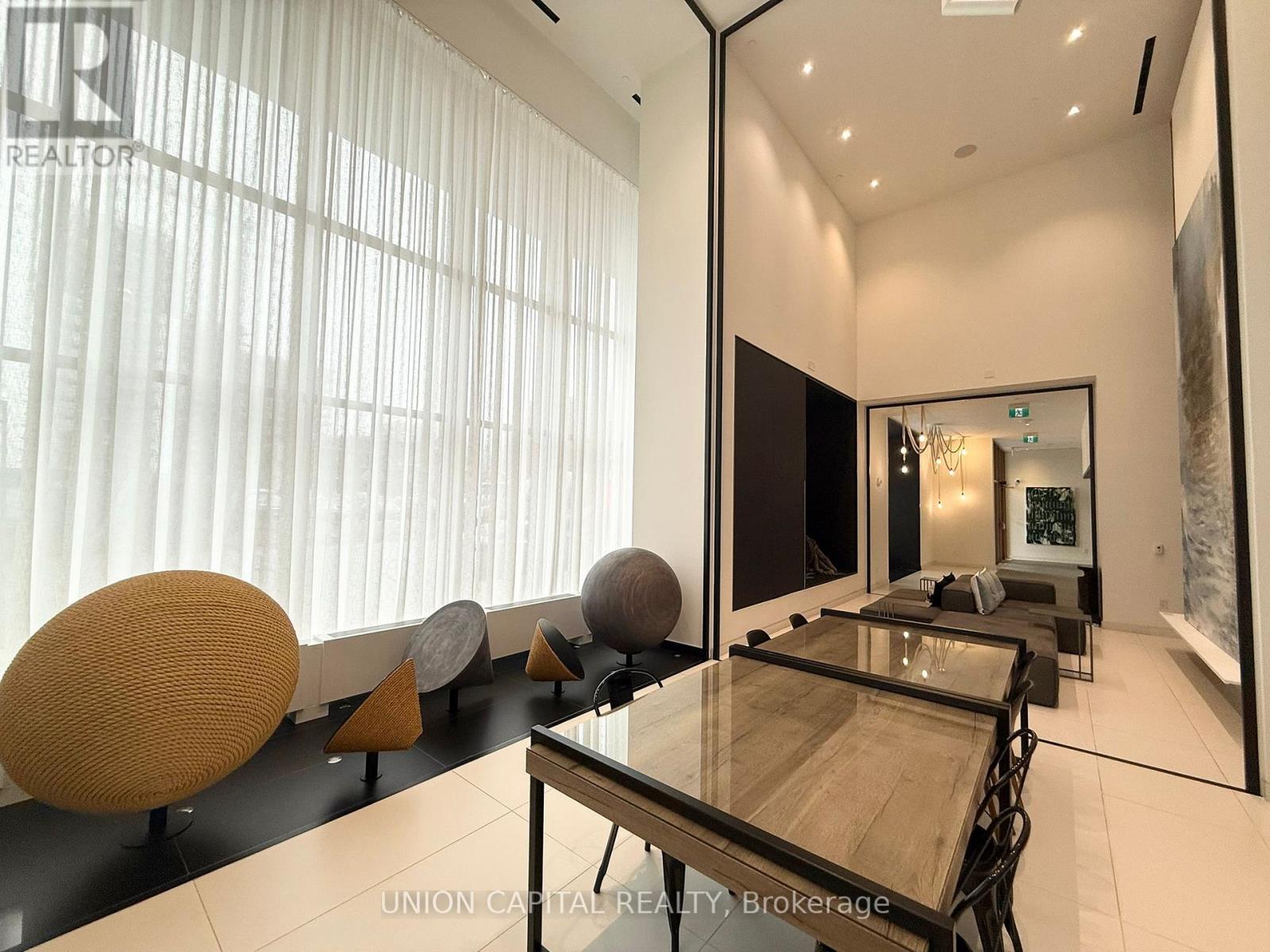 A modern dining room with a glass table and chairs.