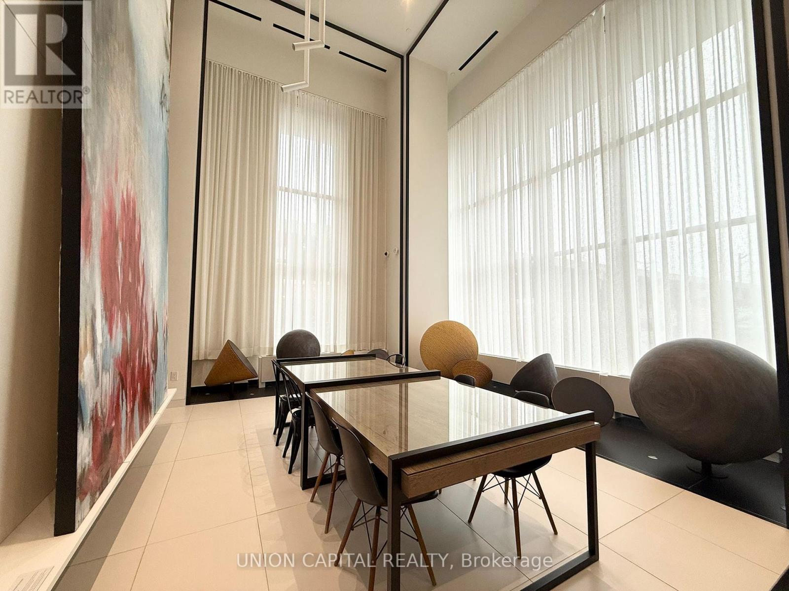A dining room with a long table and chairs.