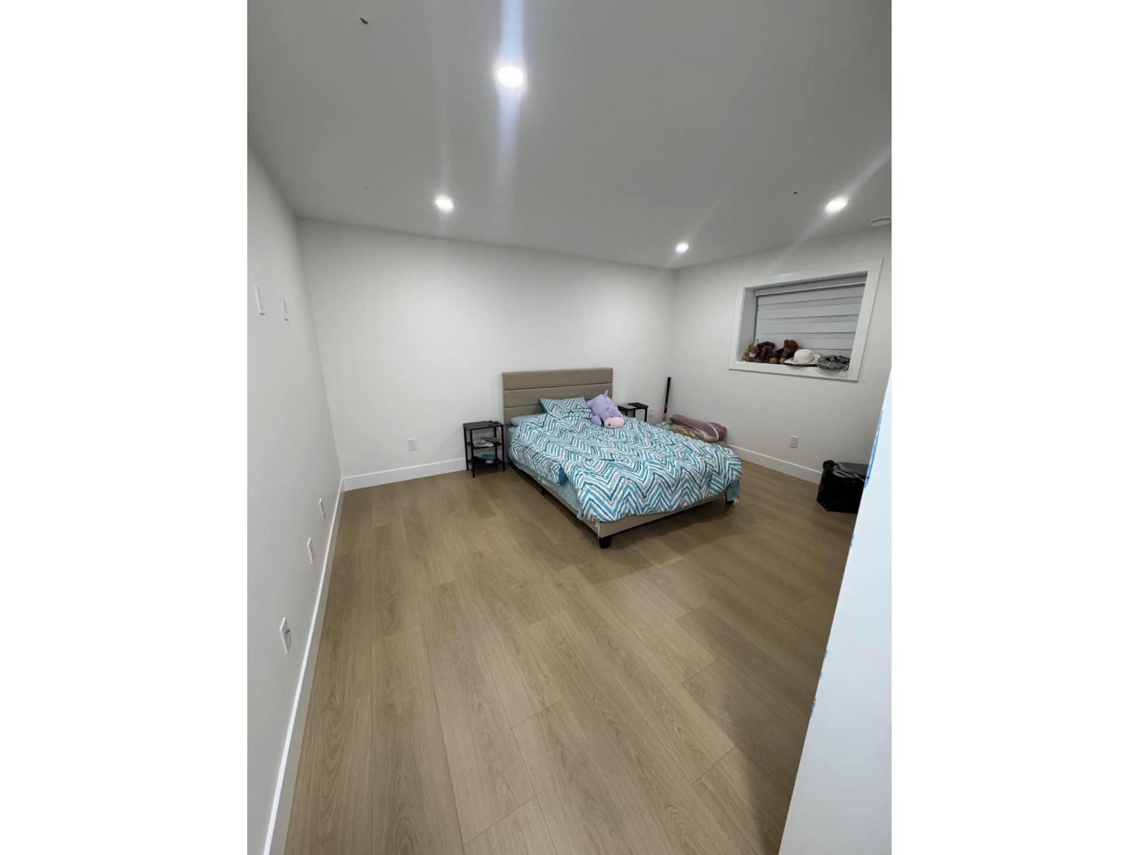 A bedroom with a bed and a suitcase.