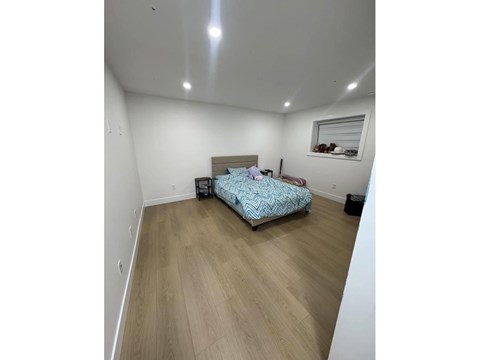 A bedroom with a bed and a suitcase.