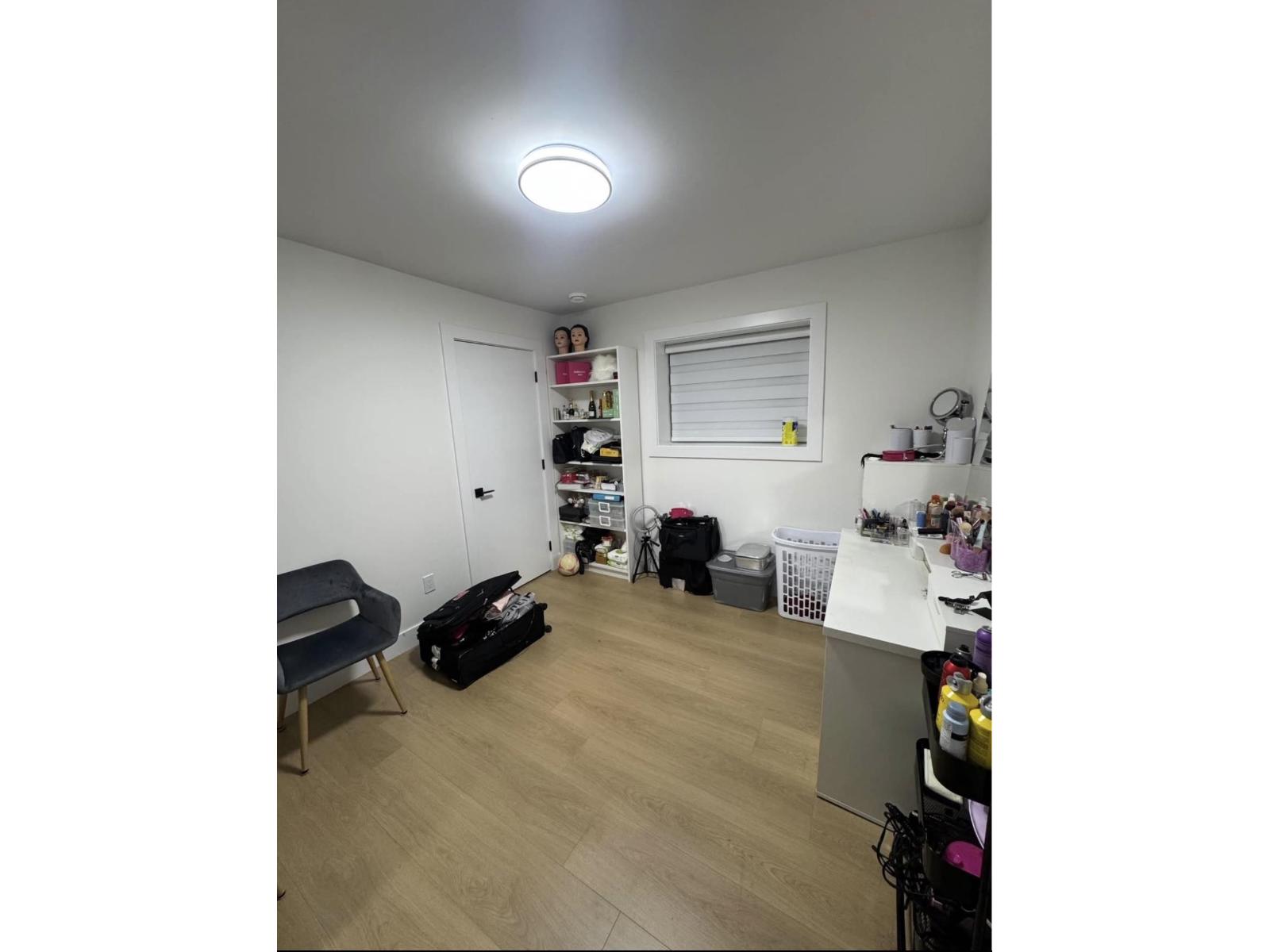 A room with a lot of items on the floor and shelves.