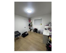 A room with a lot of items on the floor and shelves.