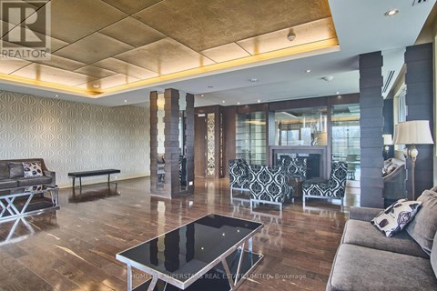 A living room with a black and white coffee table in the center.