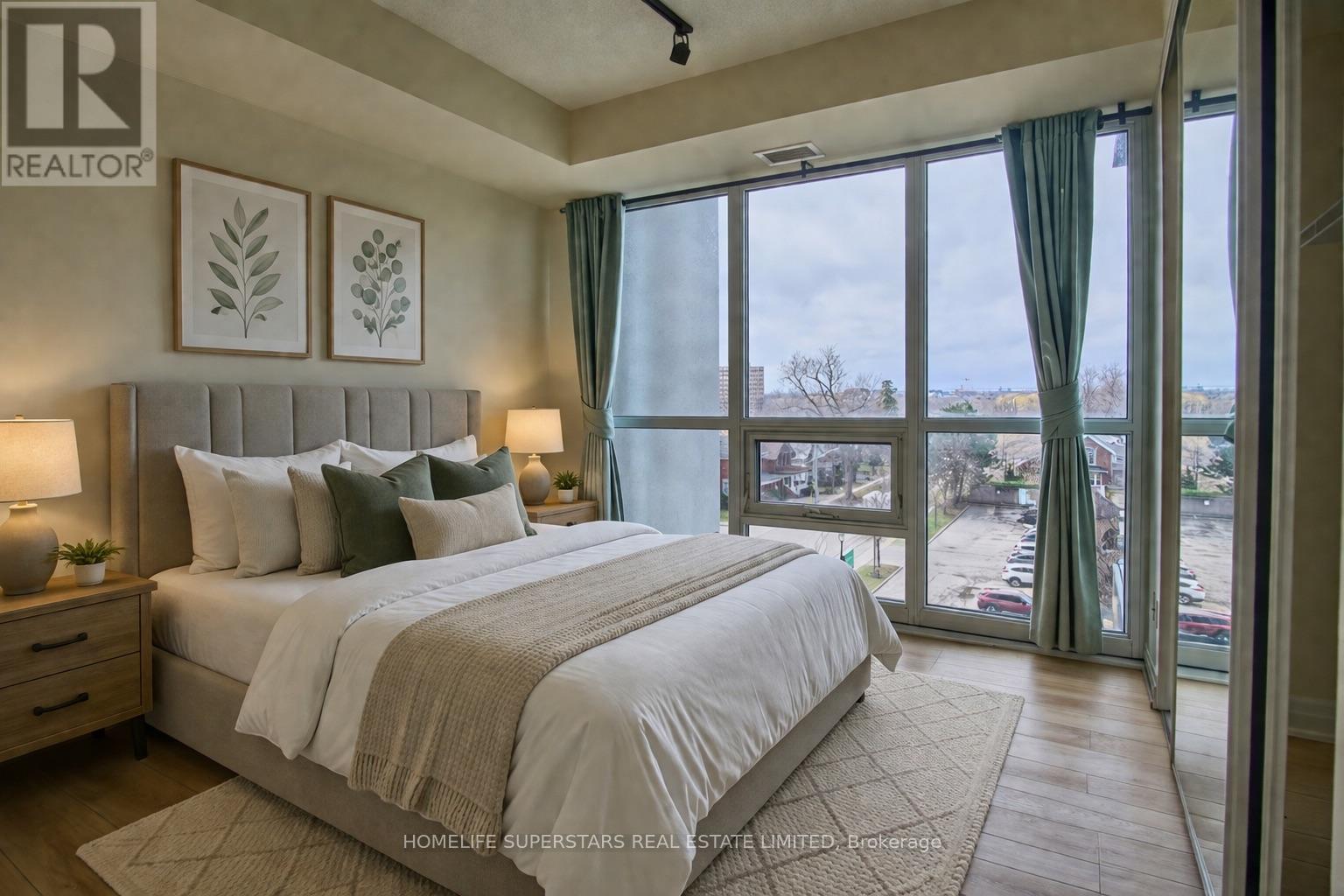 A bedroom with a large bed and a view of the city.