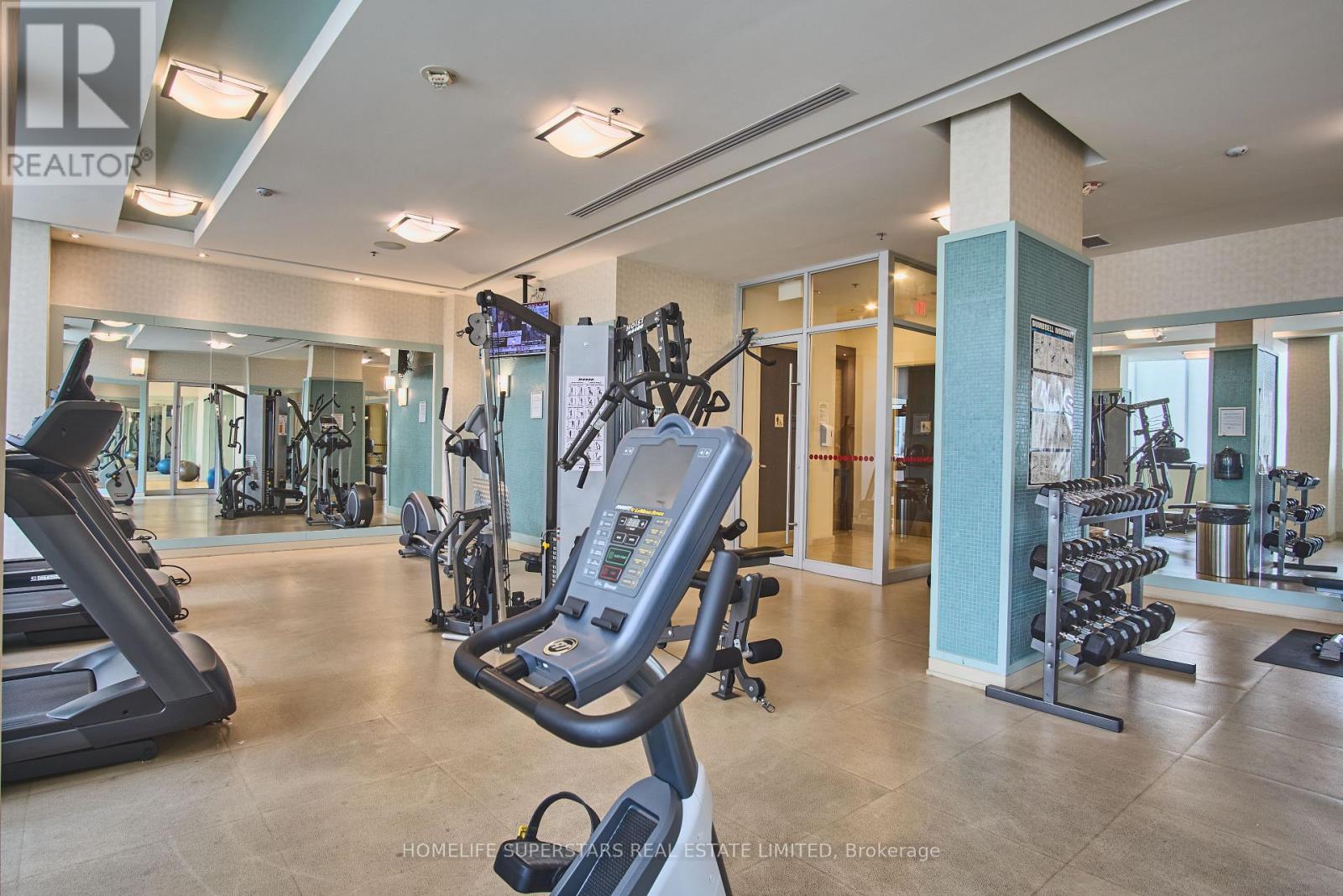 A gym with treadmills, weights, and exercise equipment.