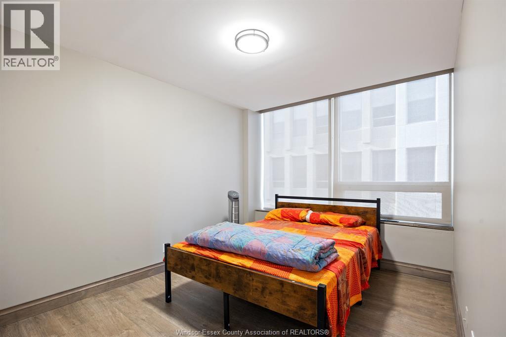 A bedroom with a bed and a window.