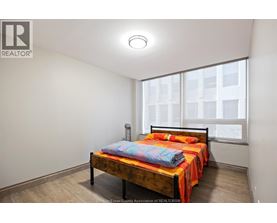 A bedroom with a bed and a window.