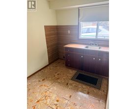 A bathroom with a sink and a window.