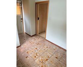 A room with a tile floor and a wooden door.