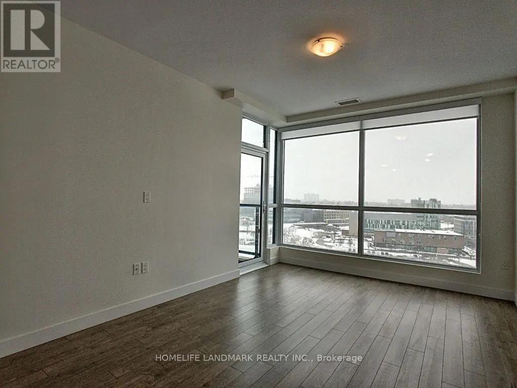 A room with a large window overlooking a cityscape.