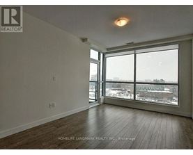 A room with a large window overlooking a cityscape.