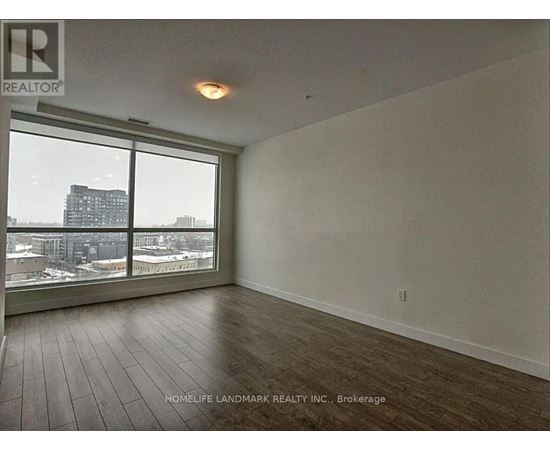 A room with a view of the city through the windows.