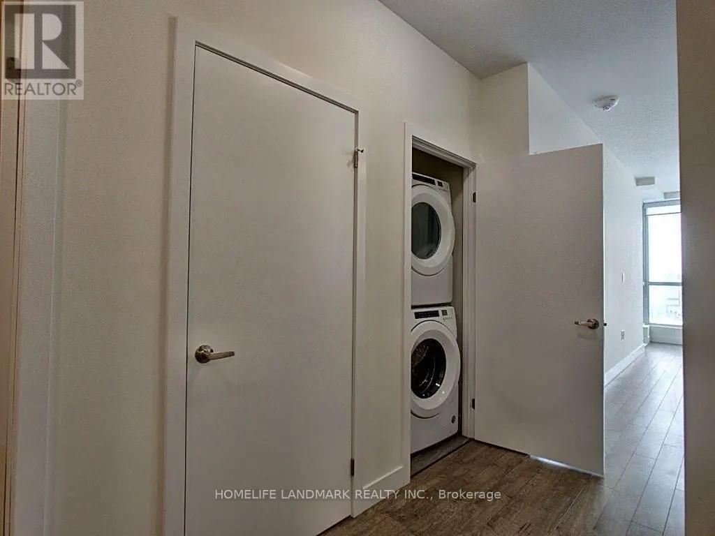 A laundry room with a washer and dryer built into the wall.