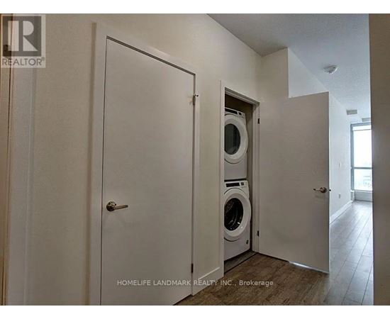A laundry room with a washer and dryer built into the wall.