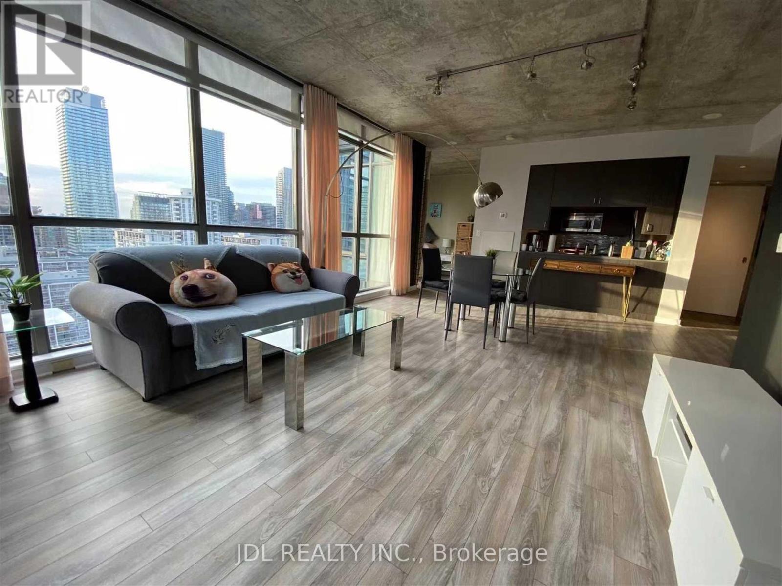 A modern living room with a view of the city skyline.