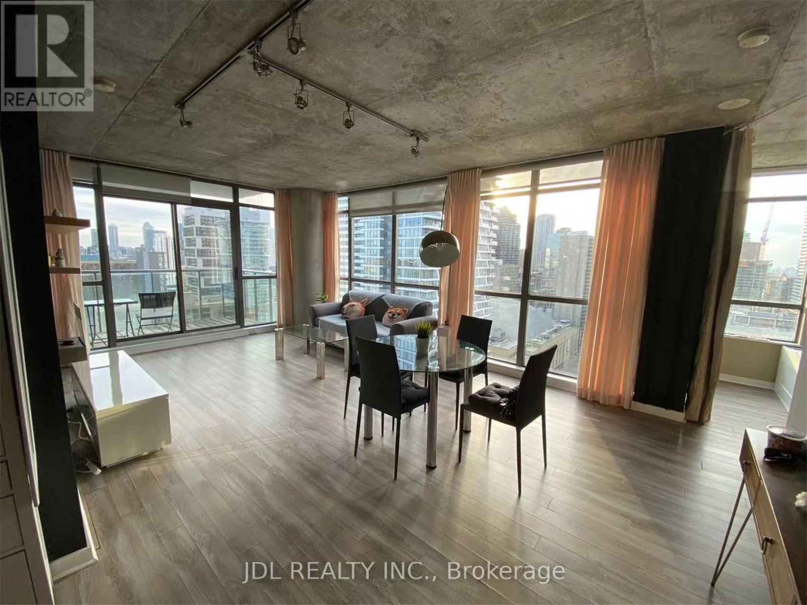 A dining room with a table set for two and a view of the city.