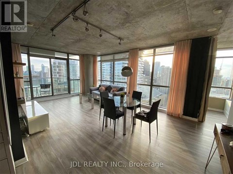 A dining room with a table set for two and a view of the city.