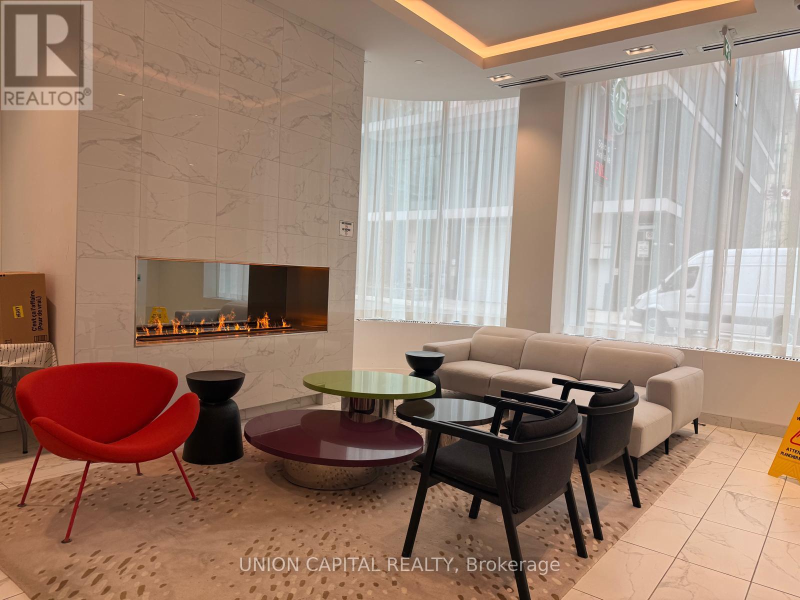 A living room with a fireplace and a variety of seating options.