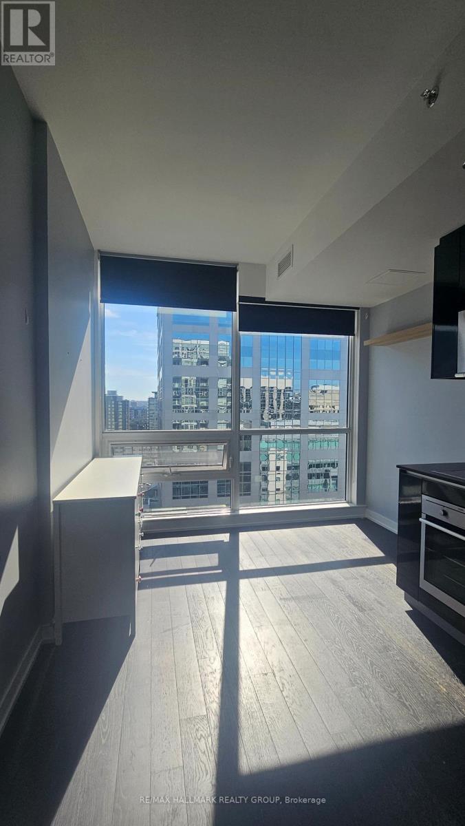 A sunny day in a modern kitchen with a view of the city.