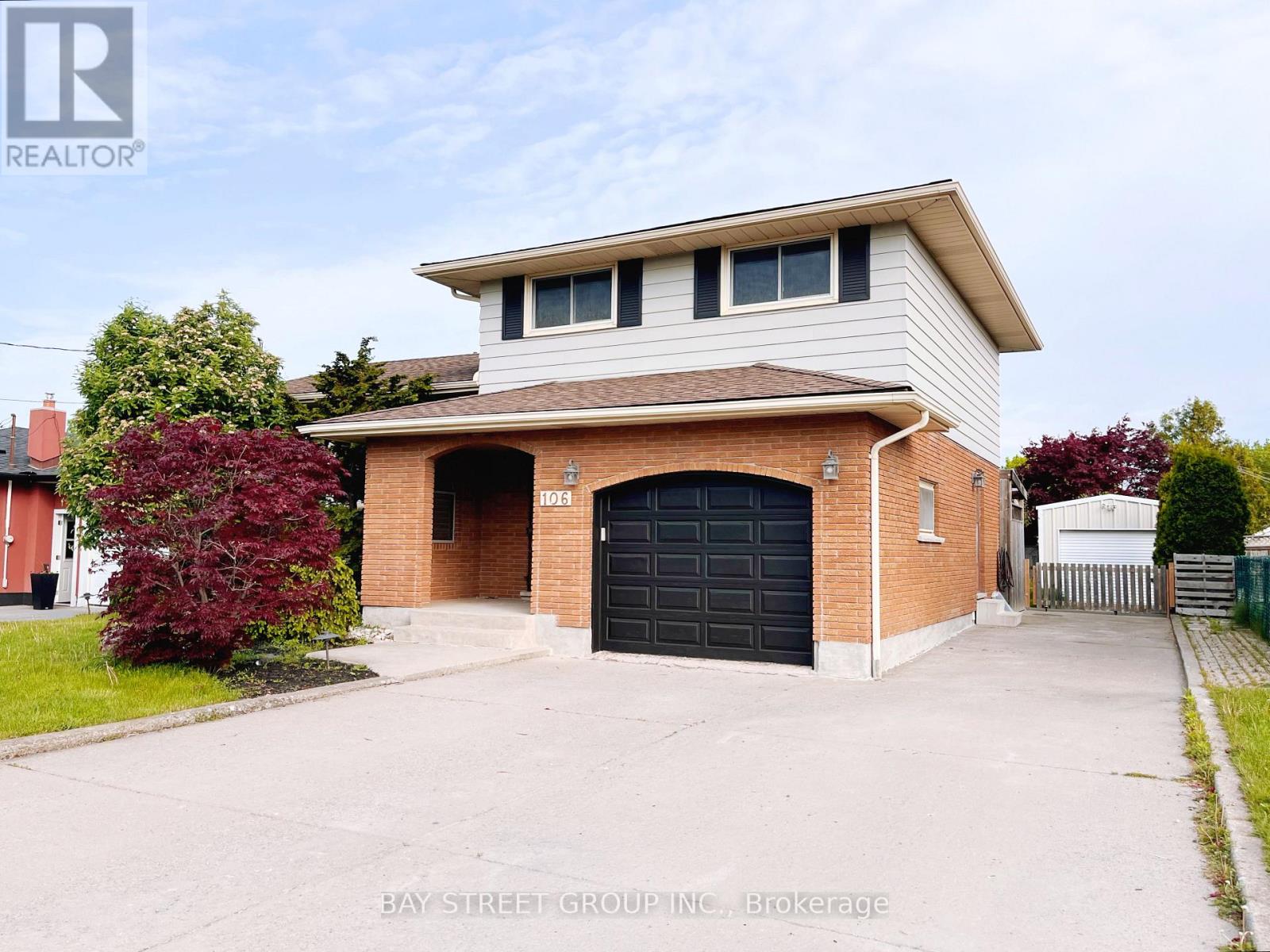 A two-story house with a garage is for sale.