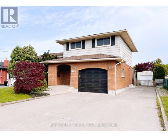 A two-story house with a garage is for sale.