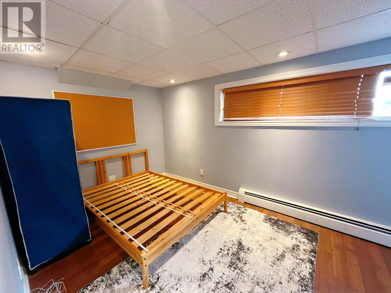 A bedroom with a wooden bed and a blue wardrobe.