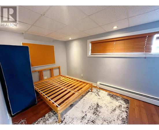 A bedroom with a wooden bed and a blue wardrobe.