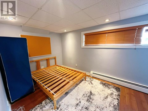 A bedroom with a wooden bed and a blue wardrobe.
