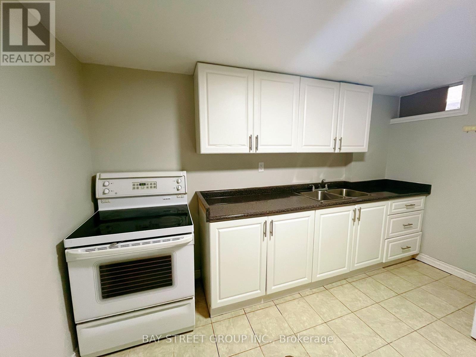 A kitchen with white appliances and cabinets.