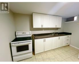 A kitchen with white appliances and cabinets.