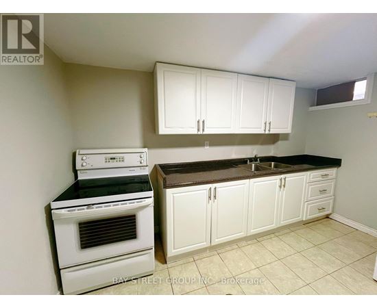 A kitchen with white appliances and cabinets.