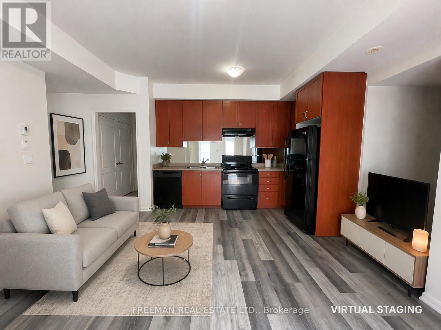 A modern living room with a grey sofa and a coffee table in the center.