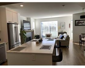A modern kitchen with a refrigerator, stove, and oven.