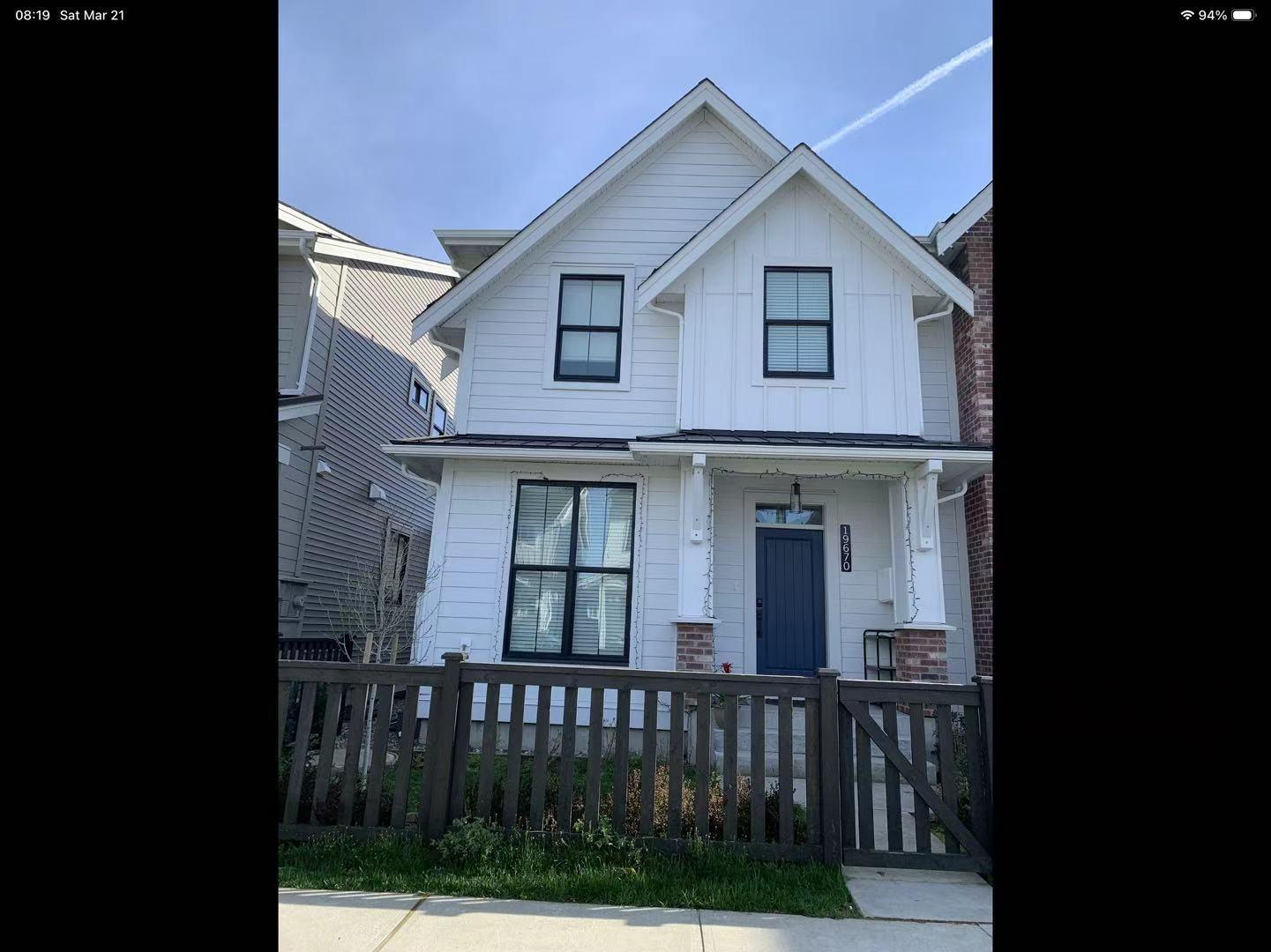 A white house with a blue door and windows.