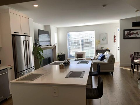 A modern kitchen with a refrigerator, stove, and oven.