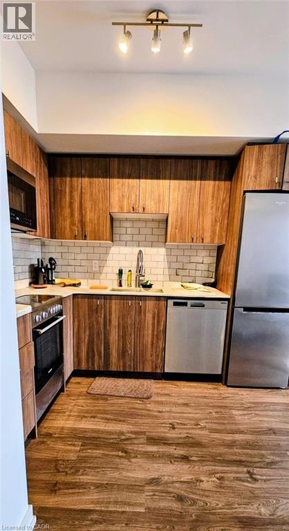 A kitchen with wooden cabinets and a white fridge.