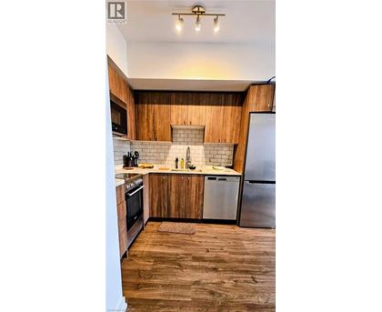 A kitchen with wooden cabinets and a white fridge.