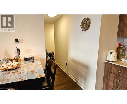 A dining room with a table set for a meal.