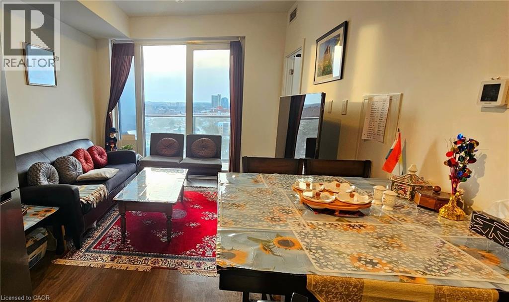 A living room with a dining table set for two with a view of the city.