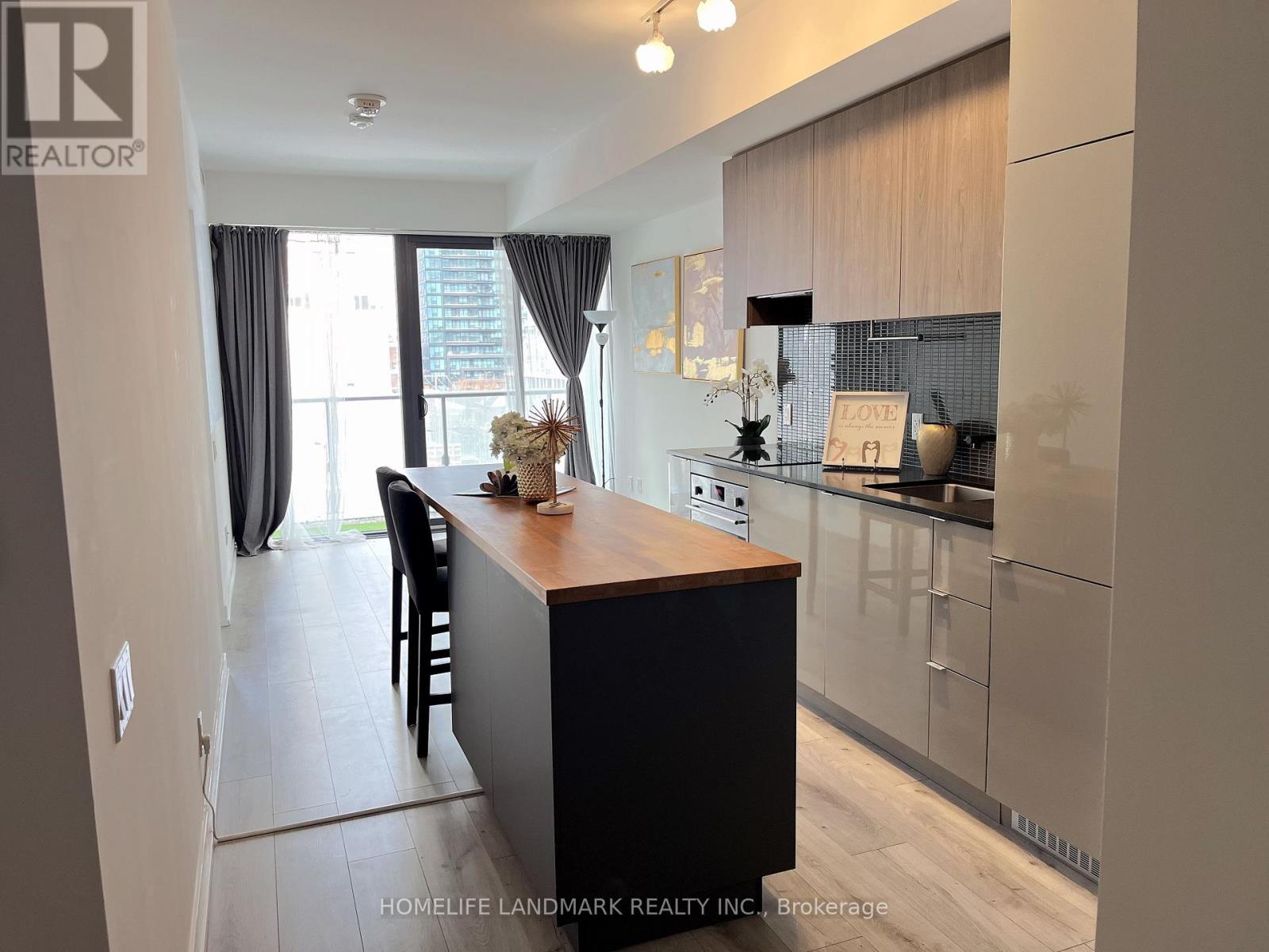 A modern kitchen with a dining table and chairs.