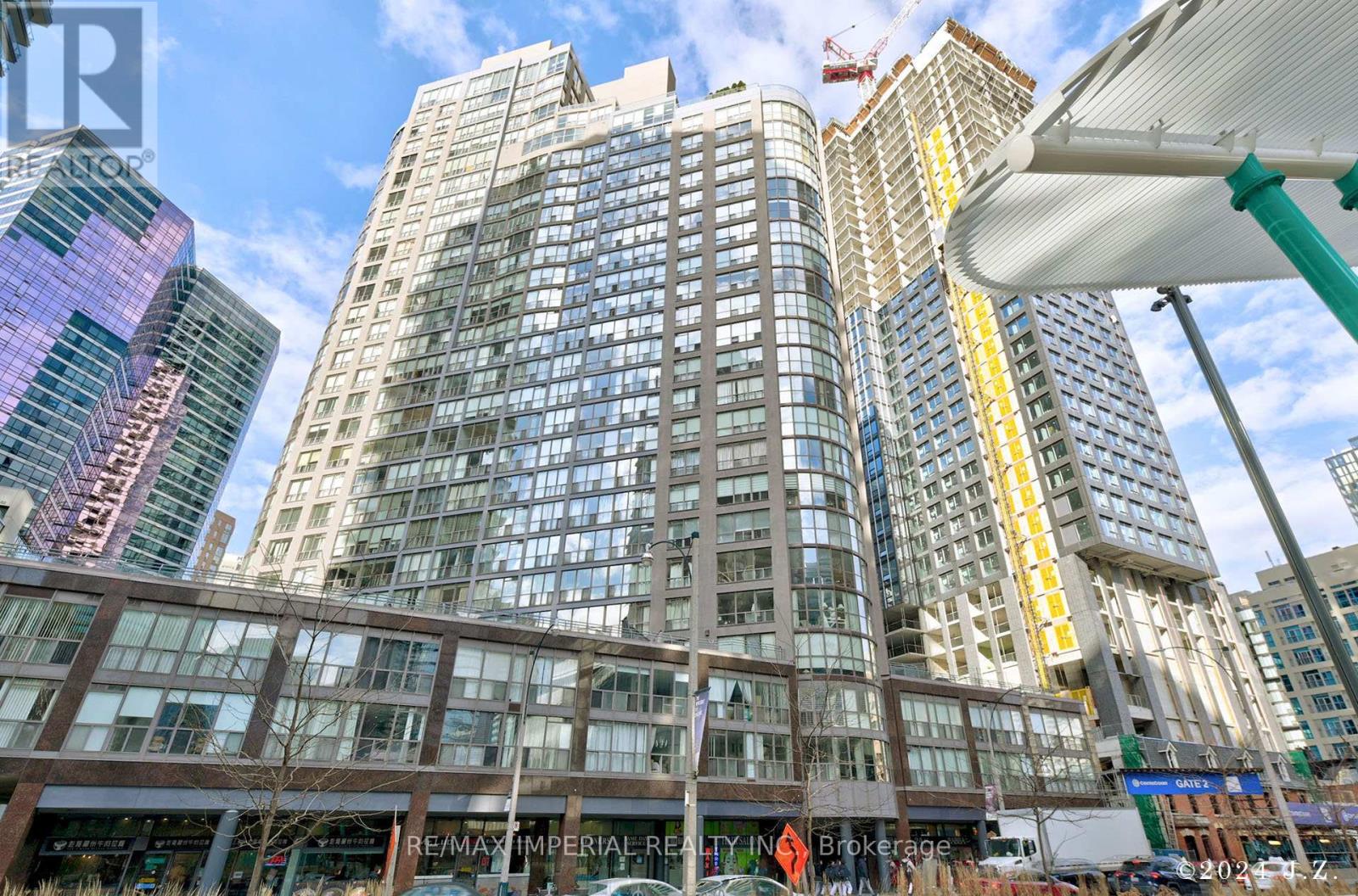 A tall building with many windows is in the foreground of the image.