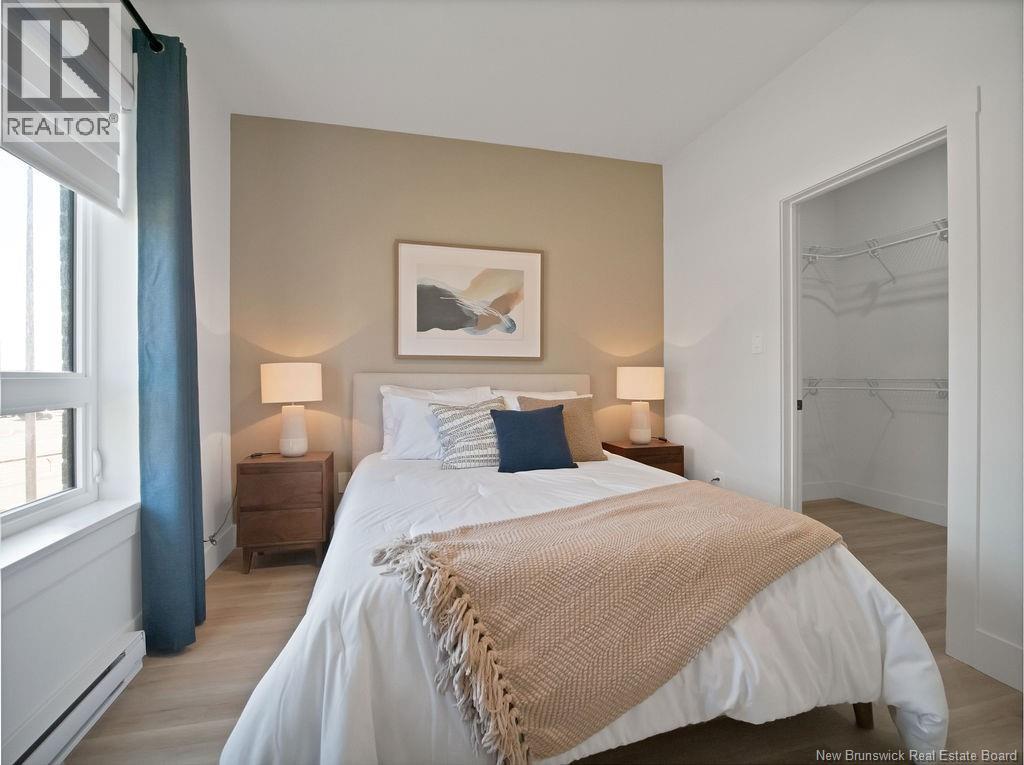 A bedroom with a large bed and a painting on the wall.