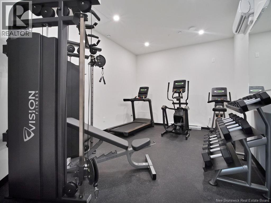 A gym with a variety of equipment including a treadmill, a stationary bike, and a bench press.