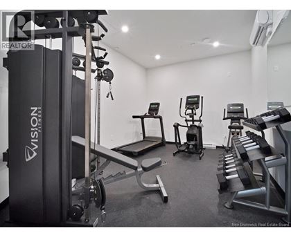 A gym with a variety of equipment including a treadmill, a stationary bike, and a bench press.